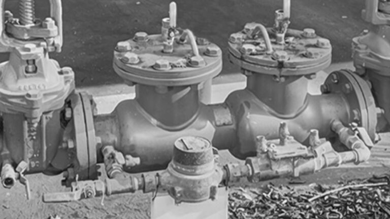 A backflow preventer installed correctly in black and white 
