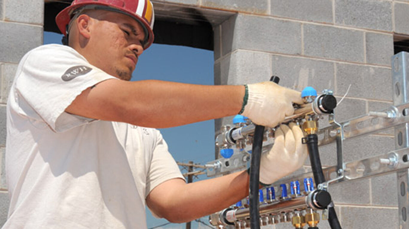 Man working with wiring for construction project.