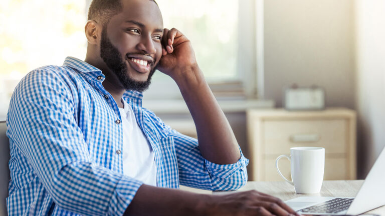 Man completing an online course on plumbing and heating 