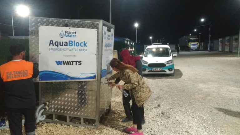 Watts employees installing Aquablock water station