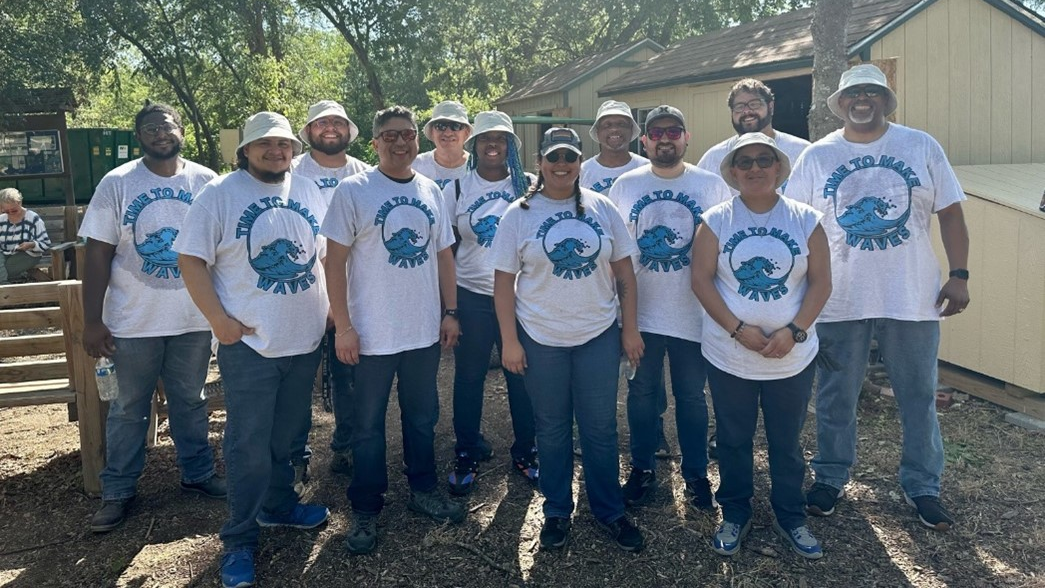 Watts San Antonio employees participating in volunteer clean up program.