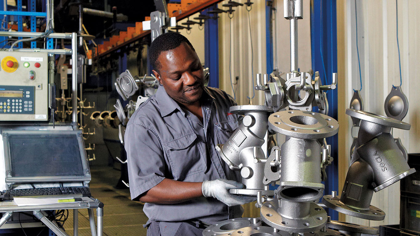 a watts employee working on parts in the factory 